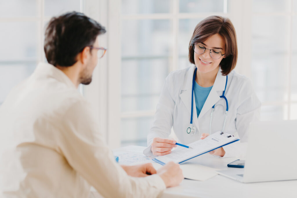 female doctor gives professional medical help to their male patient